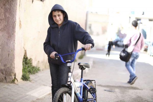 refugee-kid-bicycle-streets